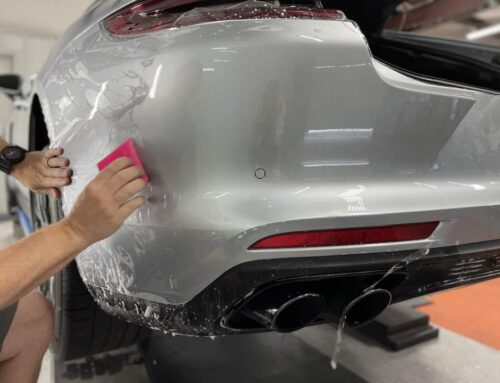 PPF being applied to the rear bumper of a Porsche